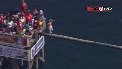 Participants compete in Gloucester’s annual ‘Greasy Pole Competition’